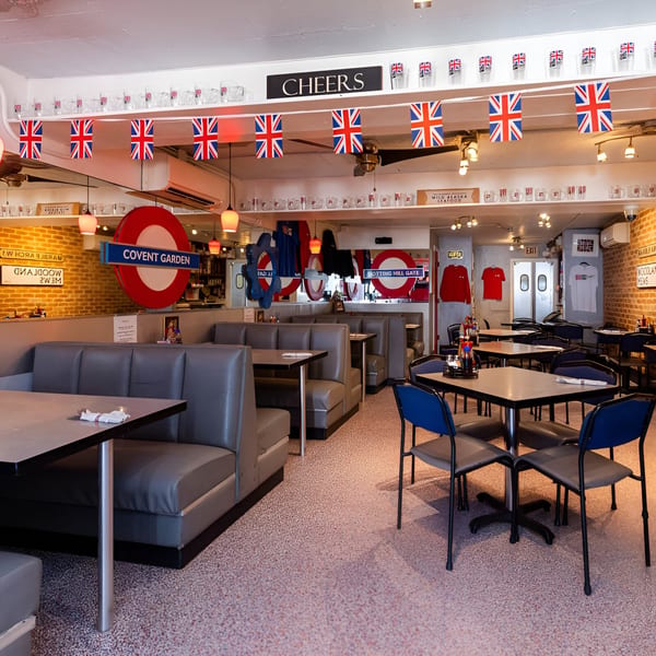 Interior of Go Fish! restaurant with booths, tables, and British-themed decor including Union Jack flags.