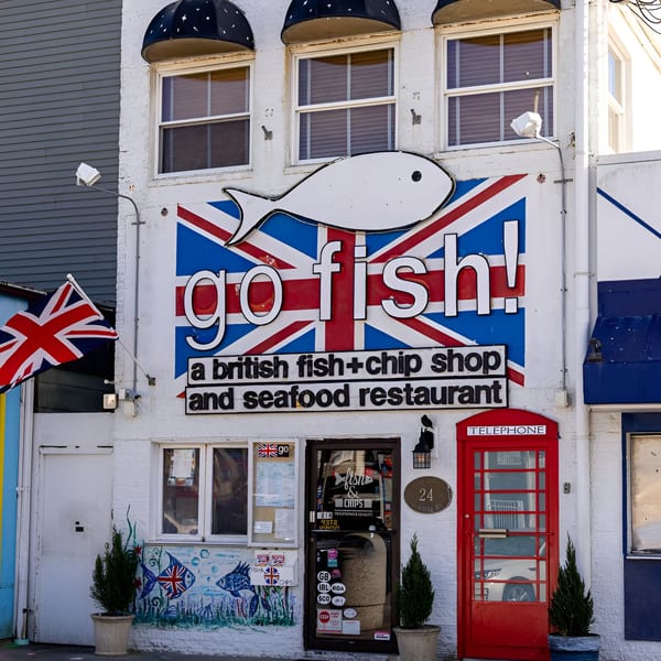 The Go Fish! restaurant exterior features a large Union Jack sign, a fish logo, and a red telephone booth.